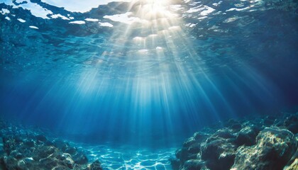 Underwater background with blue water and sun rays. Copy space