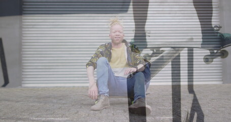 Image of man skateboarding over albino man sitting on skateboard - Powered by Adobe