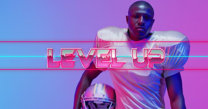 Image of level up text over american football player and neon lines