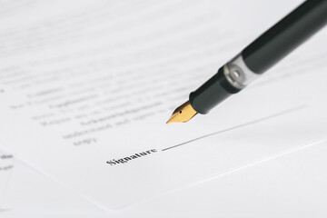 Signing notary document with fountain pen, closeup. Space for text