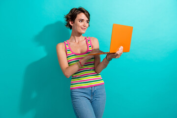 Portrait of lovely satisfied person use wireless netbook coworking isolated on turquoise color...