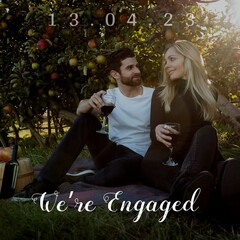 Celebrating love, a couple shares a romantic moment in an orchard, symbolizing engagement and compan
