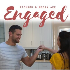 Celebrating love, a couple shares a joyful engagement moment in a cozy kitchen setting
