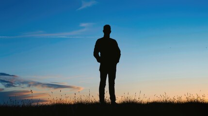A silhouette of a man standing in a field, suitable for various projects