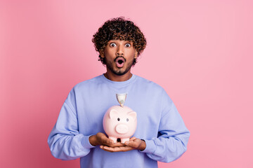 Fototapeta na wymiar Photo of surprised impressed guy wear stylish blue clothes hold piggy bank deposit financial future isolated on pink color background
