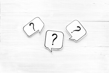 Question marks on paper speech bubbles. FAQ concept or search information concept