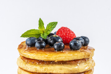 Delicious pancakes with fresh berries on white background. Food concept.