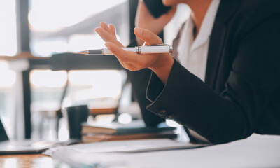 Asian Businesswoman working on laptop at the office with documents on his desk, doing planning analyzing the financial report, business plan investment, finance analysis concept