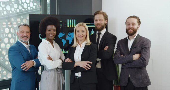Portrait of multiracial corporate business people coworkers with their female boss looking at camera for joint photo in modern office room