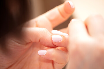 Woman removing nail varnish with acetone