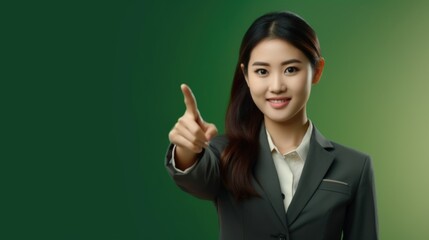 A businesswoman in a suit pointing directly at the camera. Suitable for business and marketing concepts