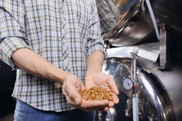 Closeup hops in pellet before brewing for craft beer on background tank. Brewery factory, Brewer control raw material for quality