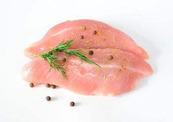 raw turkey fillet with spices and dill isolated on white background 