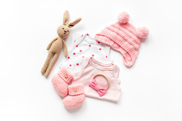 Set of baby girl dress - bodysuit with knitted hat and boots, top view. Kids clothing flat lay