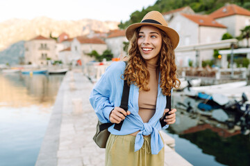 Young tourist walks the streets and enjoying architecture of the city. Lifestyle, travel, tourism, active life.