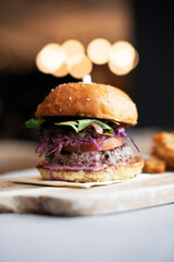Burger with fries on blurry background