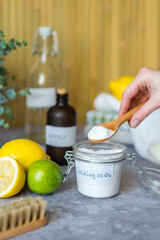 Eco-friendly cleaning products white vinegar, baking soda, lemon, brush. Green cleaning alternatives on different surfaces remove stains. Conscious and environmentally friendly. Zero waste concept.