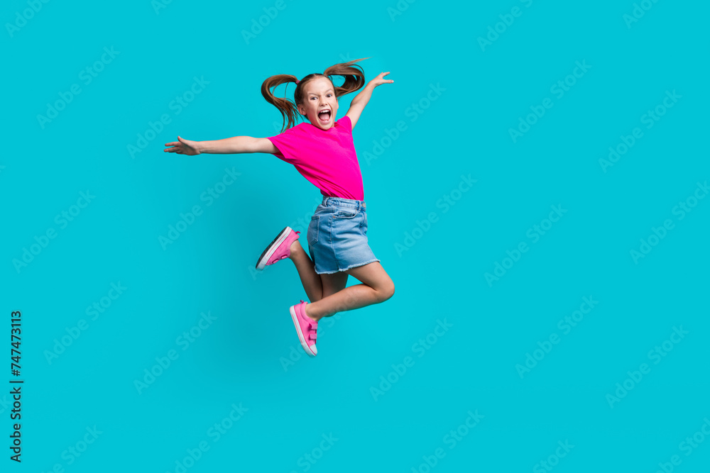 Sticker Full length photo of carefree cute flying girl wear stylish t-shirt denim skirt hold arms like wings isolated on teal color background