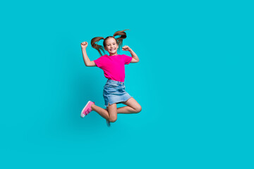 Full length photo of overjoyed nice flying girl wear stylish t-shirt denim skirt raising fists pass exam isolated on teal color background