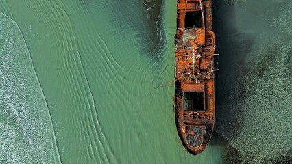 Aerial view of a ship aground and rusty on the coast of Cabo San Pablo