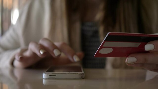 Seamless Transactions: Girl's Hands Swiftly Make Mobile Credit Card Payment