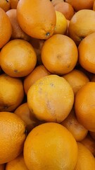 Close up pile of tasty fresh oranges sold at the market as a background.