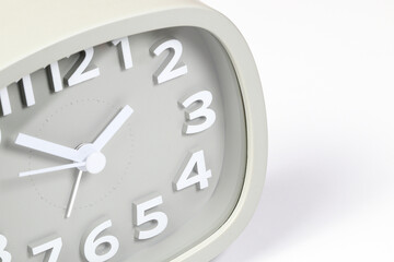 Close up Cheap gray quartz alarm clock isolated on white background.