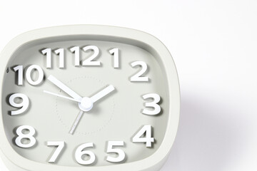 Close up Cheap gray quartz alarm clock isolated on white background.