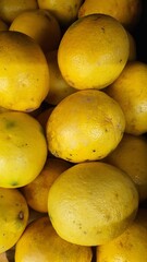 Close up pile of tasty fresh oranges sold at the market as a background.