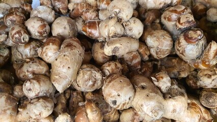 Close up pile of tasty fresh aromatic ginger sold at the market as a background.