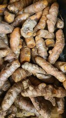 Close up pile of tasty fresh turmeric sold at the market as a background.