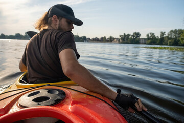Sportsman paddles gracefully on river basking in sunshine. With ease man displays expertise in...