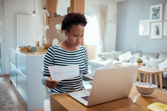 Stressed woman using laptop at home