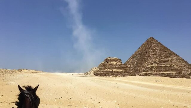 A dust devil whirls around at the Giza Necropolis in Cairo Egypt