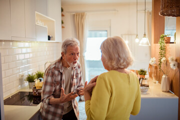 Senior couple arguing in the kitchen at home