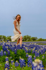 A Lovely Brunette Model Poses In A Field Of Bluebonnet Flowers In A Texas Prarie