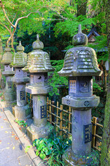 Fototapeta na wymiar Japanese stone lantern in the garden, beautiful Autumn scenery in Japan.