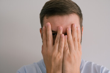 man covering his eyes, hide from reality concept