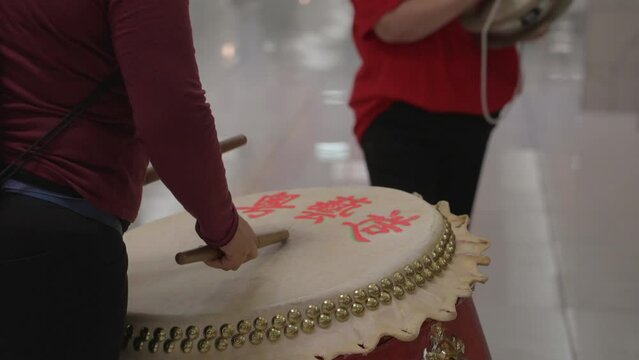 This video shows a close up view of a festive drummer and cymbal player using their instruments. 