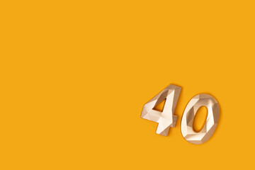 Golden number fourty on a yellow background. Place for your text.