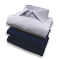 stack of plain cotton shirts on a white background