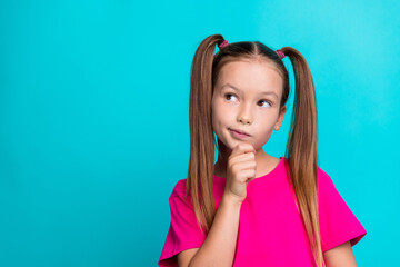 Photo of pensive creative schoolchild arm touch chin look empty space isolated on aquamarine color background