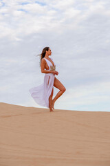 Fototapeta na wymiar Sculpted by Nature: Model's Grace Amidst Imperial Sand Dunes, California's Timeless Beauty Captured in Mesmerizing Photoshoot