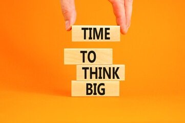 Time to think big symbol. Concept words Time to think big on beautiful wooden block. Beautiful orange table orange background. Businessman hand. Business and time to think big concept. Copy space.