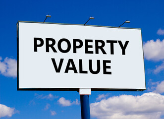 Property value symbol. Concept words Property value on beautiful white billboard. Beautiful blue sky white cloud background. Business property value concept. Copy space.