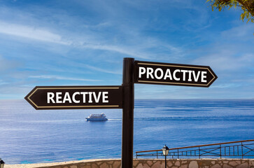 Proactive and reactive symbol. Concept word Proactive Reactive on beautiful signpost with two arrows. Beautiful blue sea sky clouds background. Business proactive and reactive concept. Copy space.