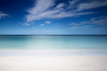 Fototapeta na wymiar Symmetrical tropical white sand beach and calm sea background, calm