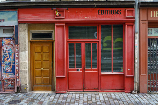 Paris France 3 may 2023 : typical and traditionnal french boutique , red painted bookstore