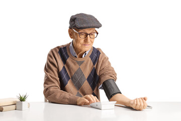 Elderly man using a digital blood pressure device