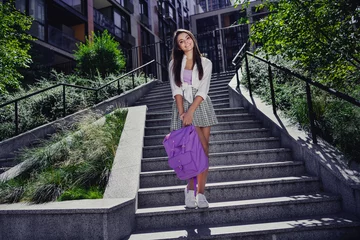  Full length photo of adorable lovely cute girl dressed stylish clothes hold backpack autumn september warm weather city center outdoors © deagreez